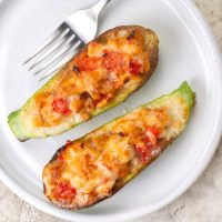 Dinner with baked in oven Zucchini stuffed with chicken meat, belle peppers, tomatoes and cheese. Directly Above.