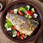 Baked seabass with Greek salad. Top view